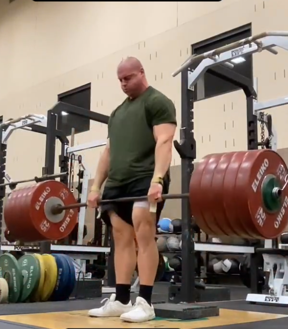 Person deadlifting a barbell with weights in a gym setting, wearing Ascent Gen 2 sneaker in white/red