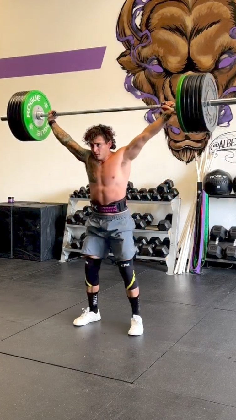 Man doing Crossfit working, lifting weights in a gym wearing Icarus Ascent Gen 2 barefoot shoe in white/red